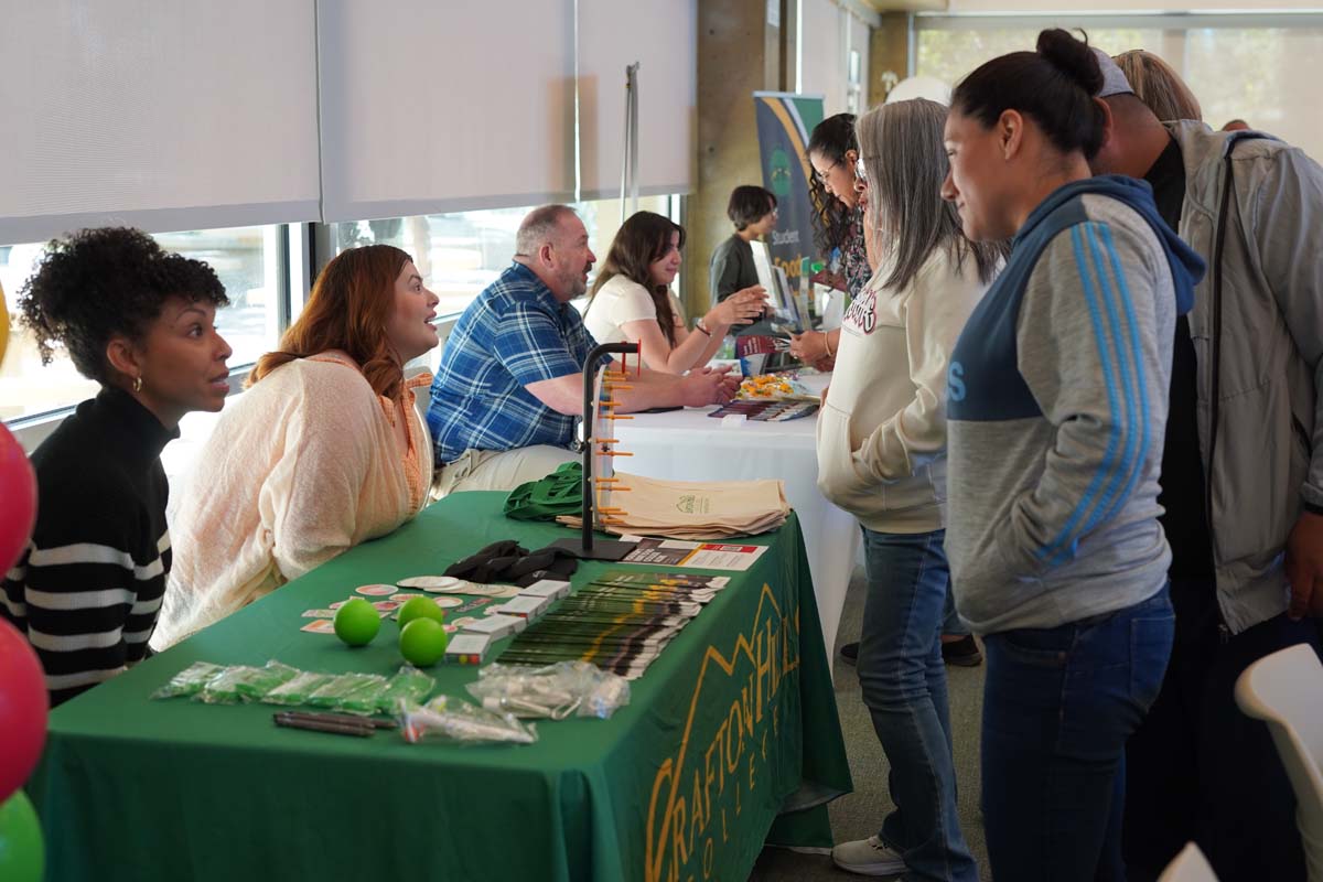 People asking questions at booths