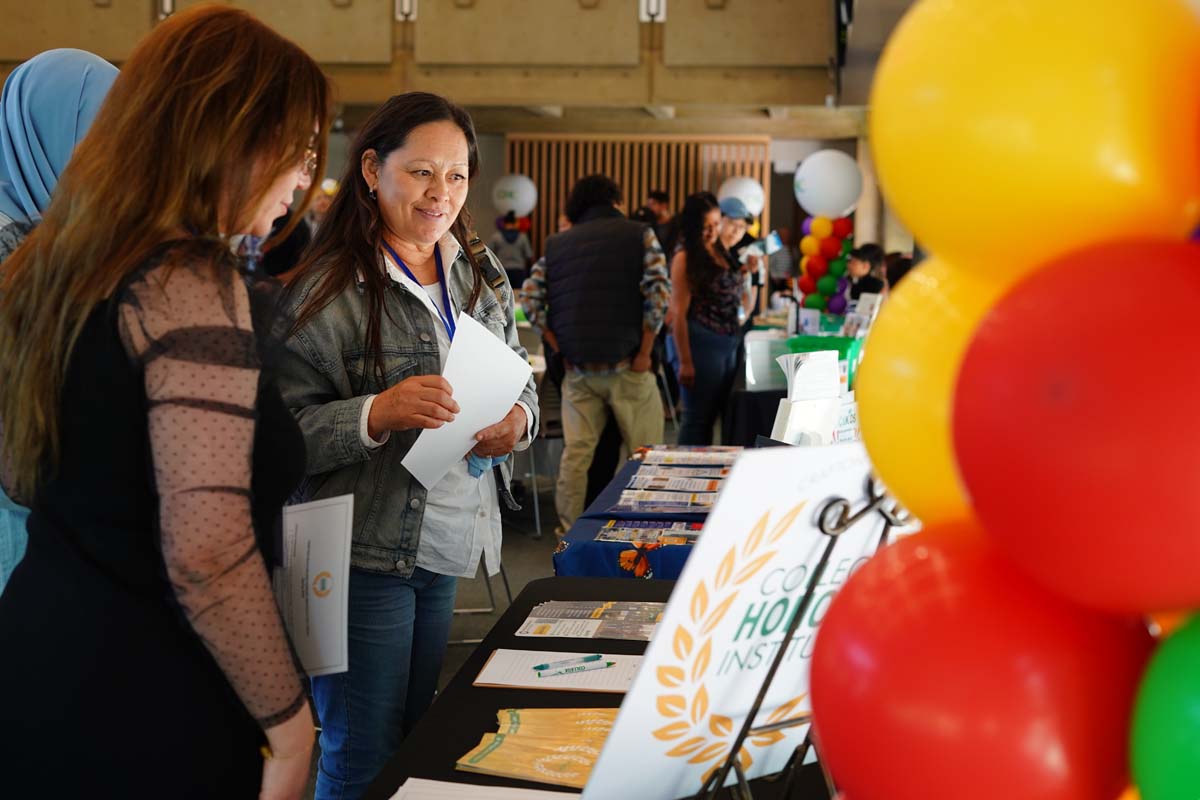 People asking questions at booths