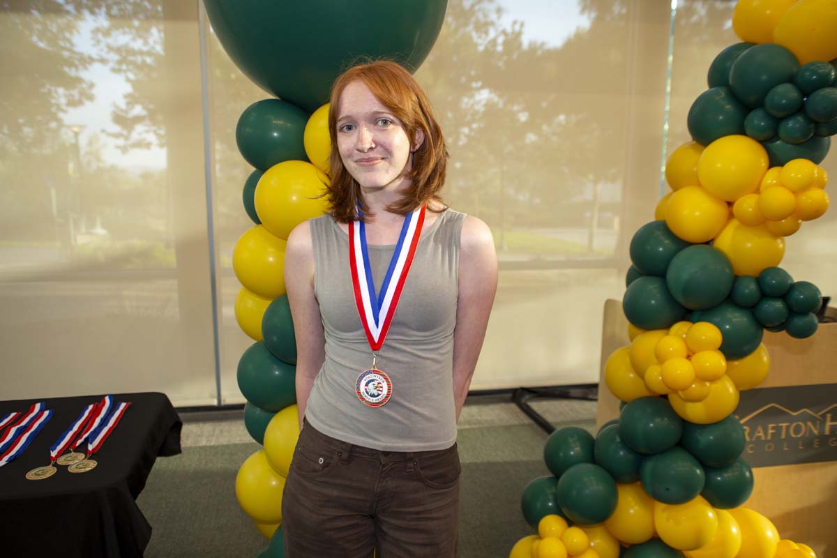 Student posing with a medal
