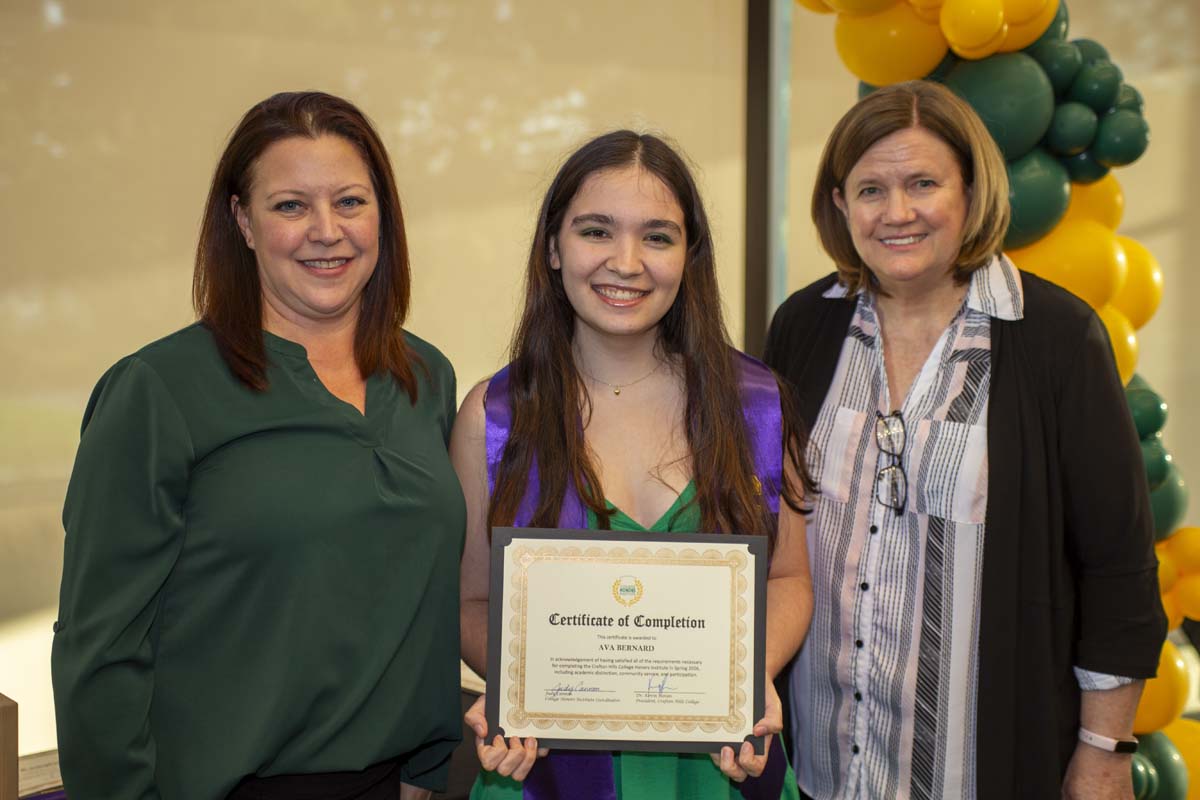 Student with a certificate standing with faculty