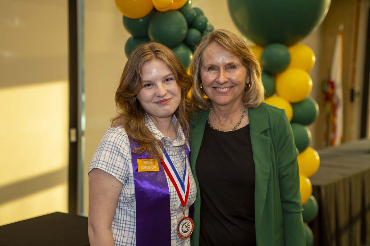 Student posing with honors coordinator