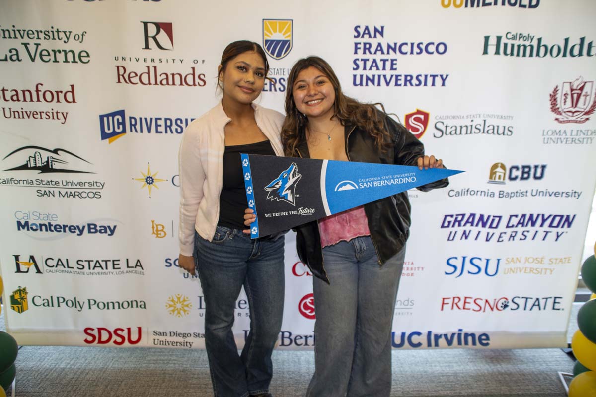 Two students with CSUSB transfer flag