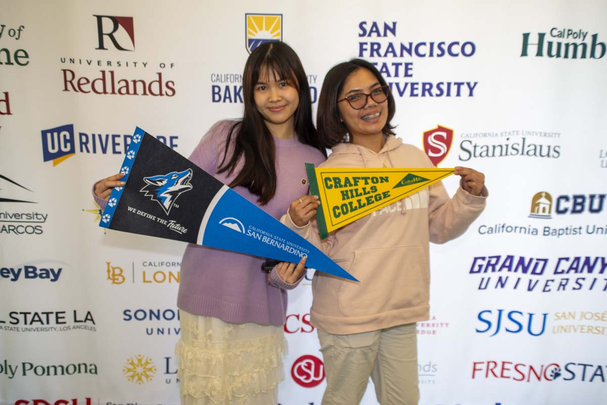 two studenst with CSUSB and Crafton transfer flag