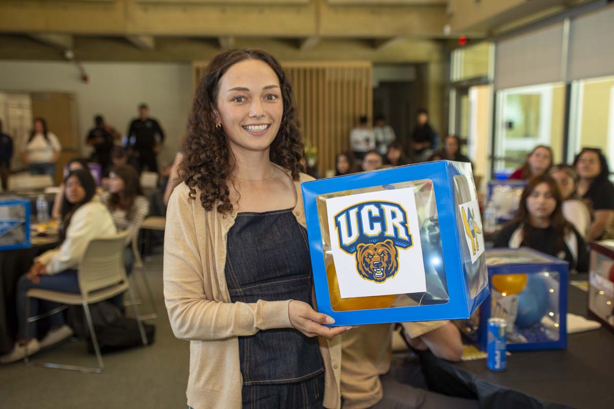 Student posing with UCR table decor