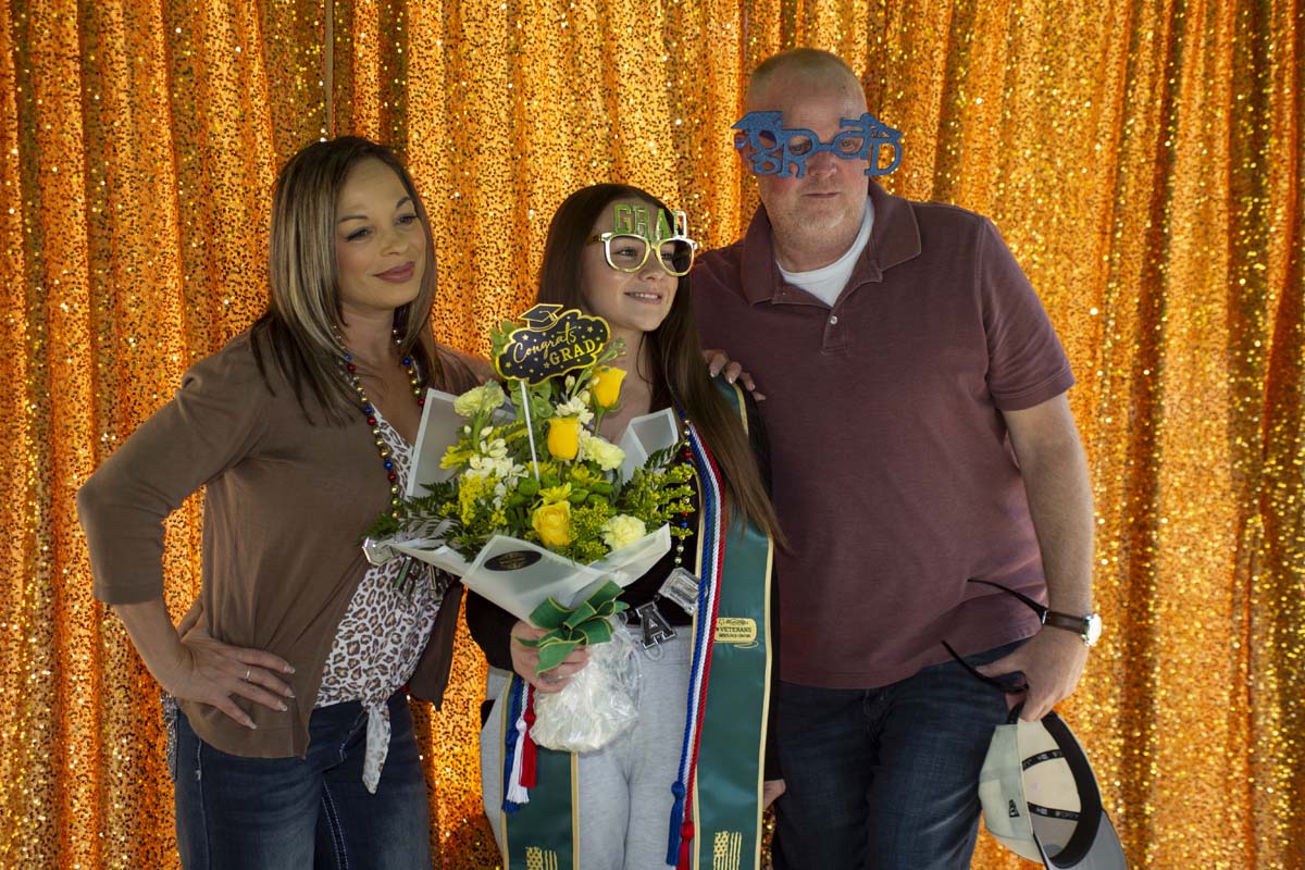 Grad with her family in the photo booth