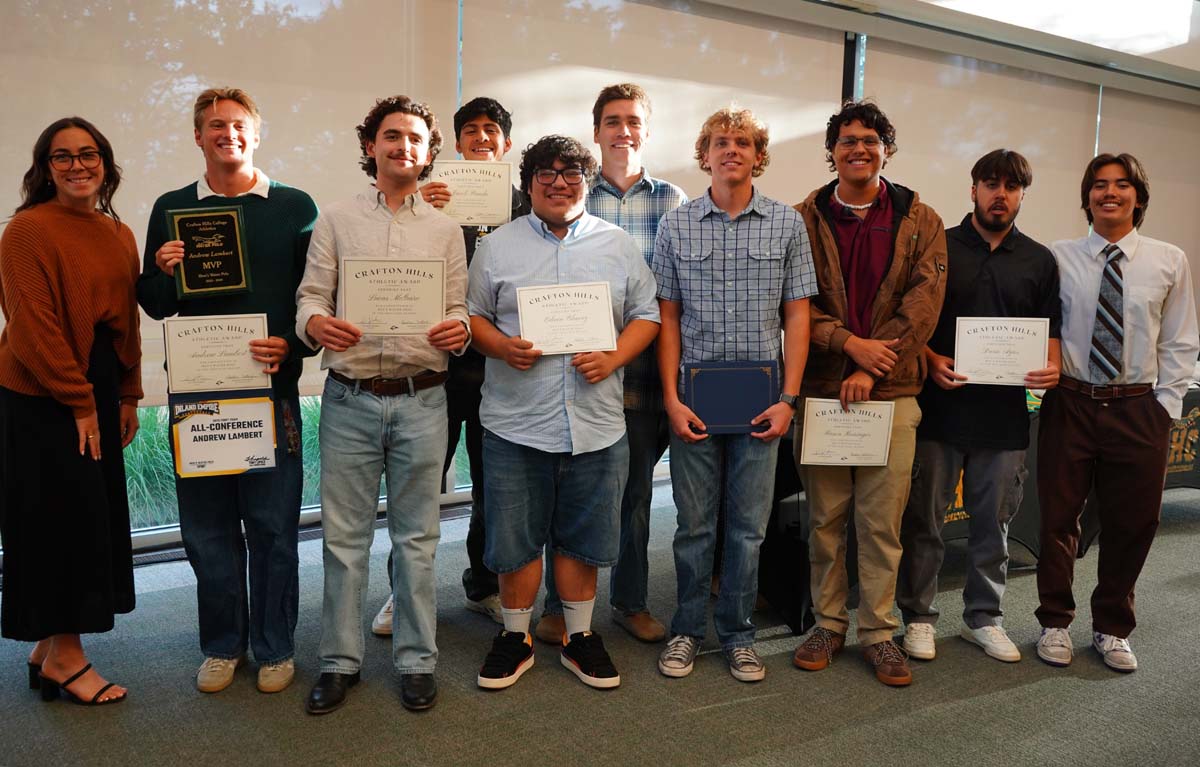 Team standing with certificates