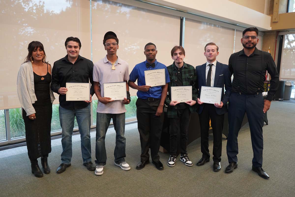 Team standing with certificates