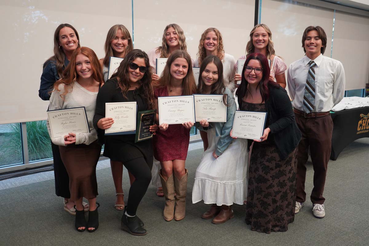 Team standing with certificates