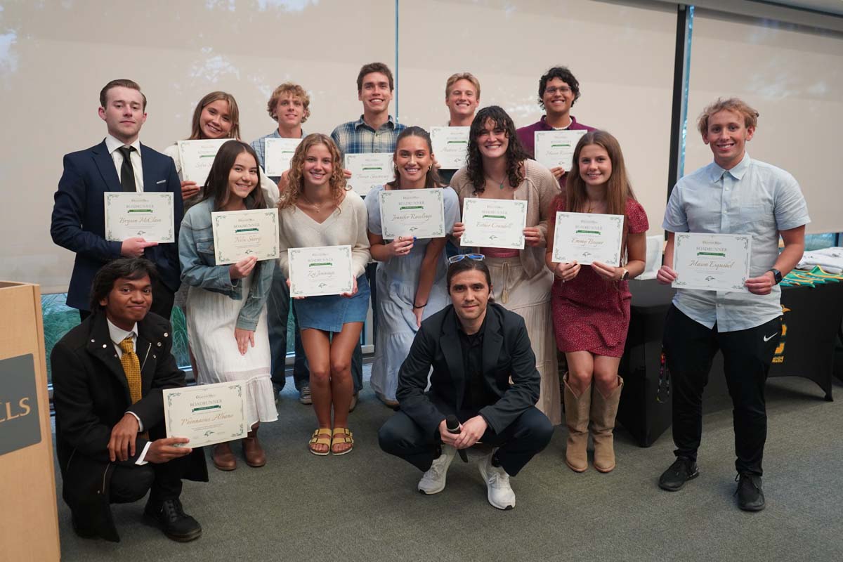 Team standing with certificates