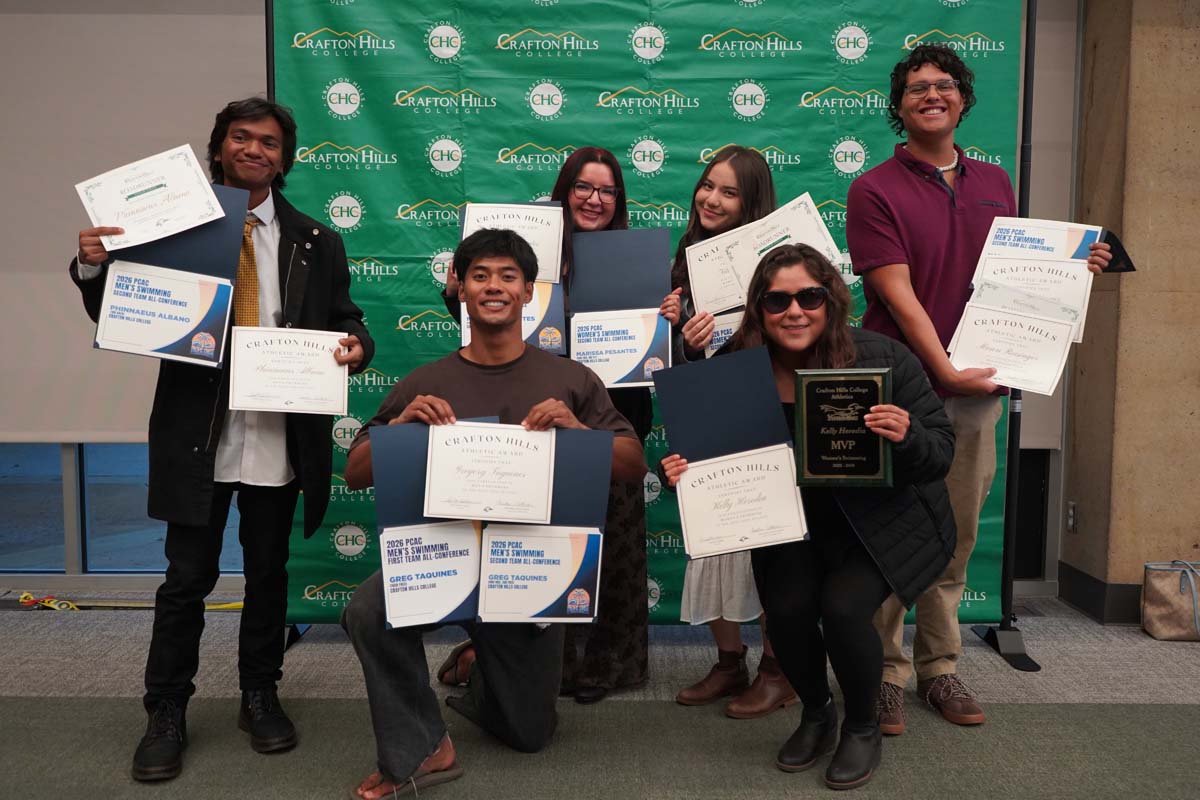 Team standing with certificates