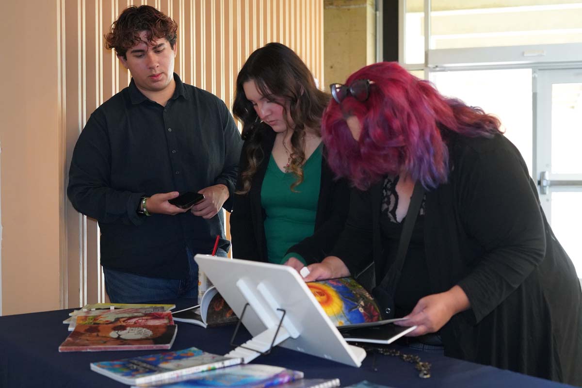 Three students looking at display