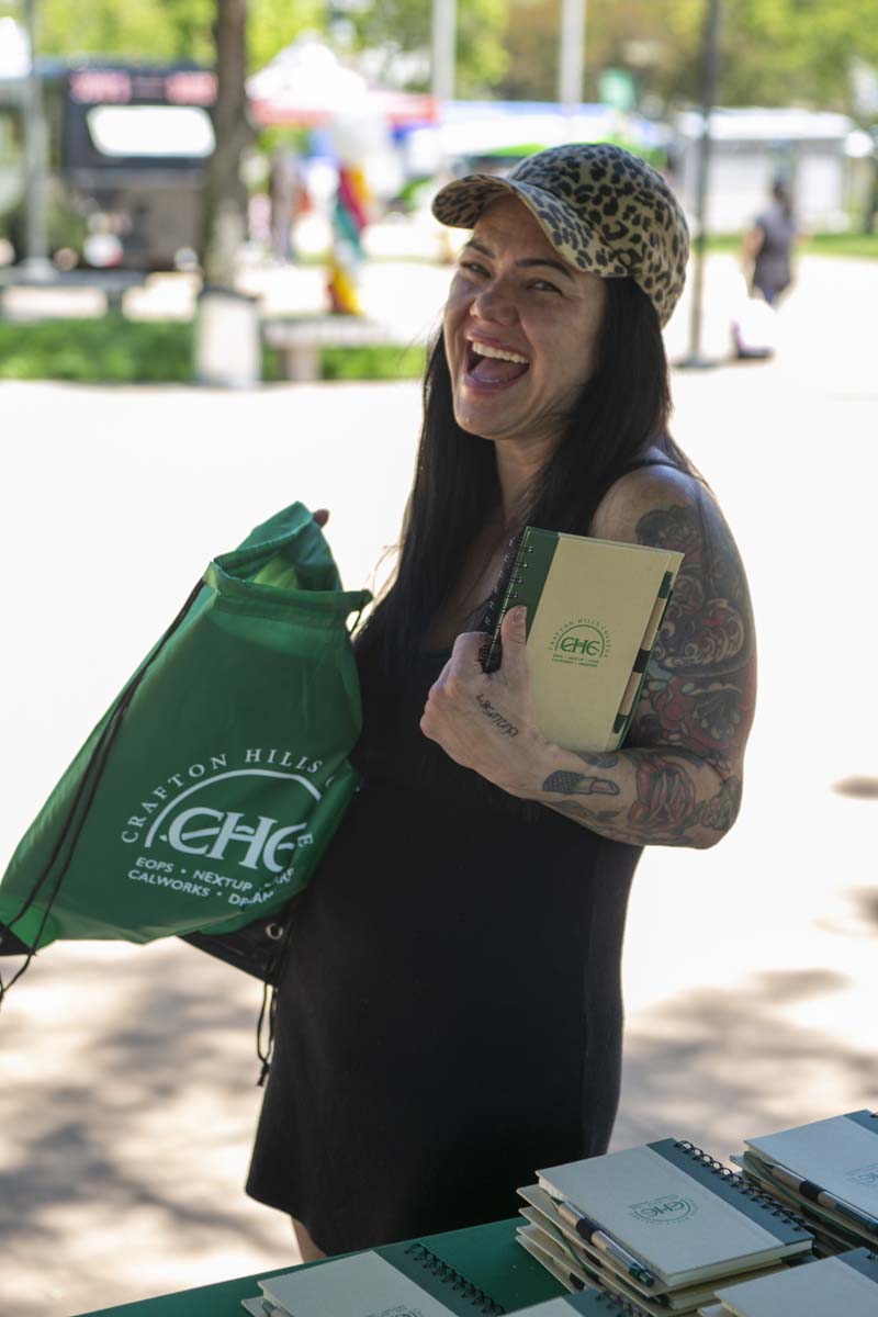 Student smiling while holding swag