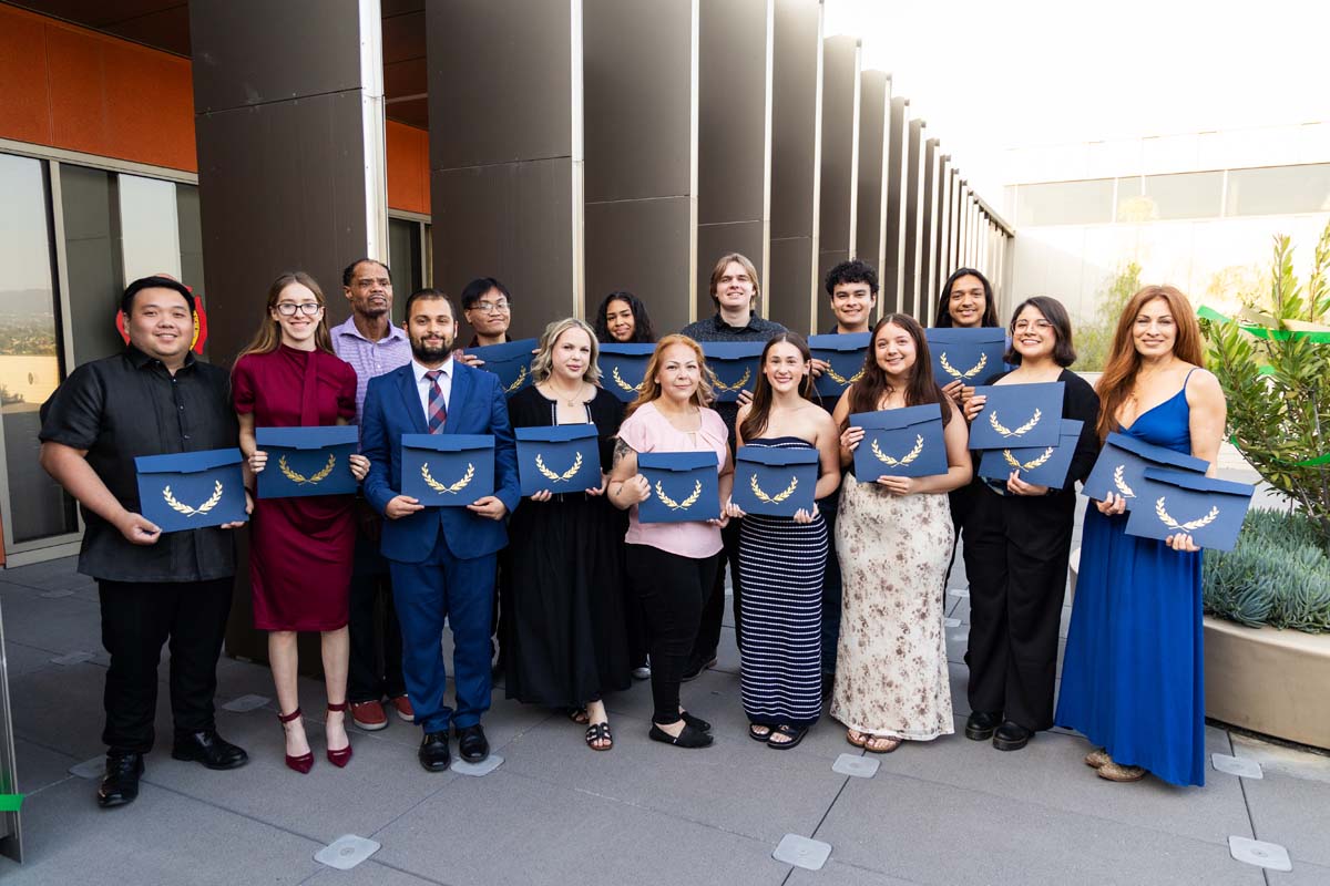 Group photo of all grads with certificates