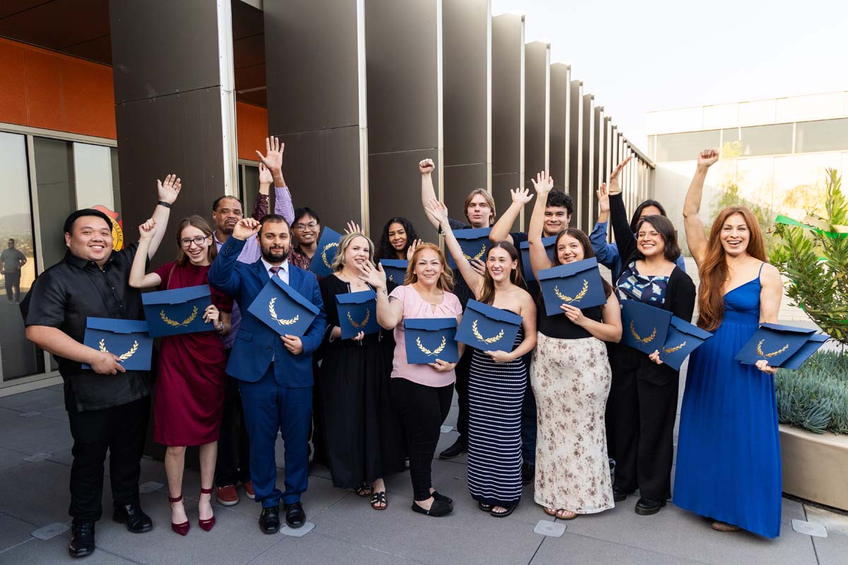 Graudate group photo with them all celebrating