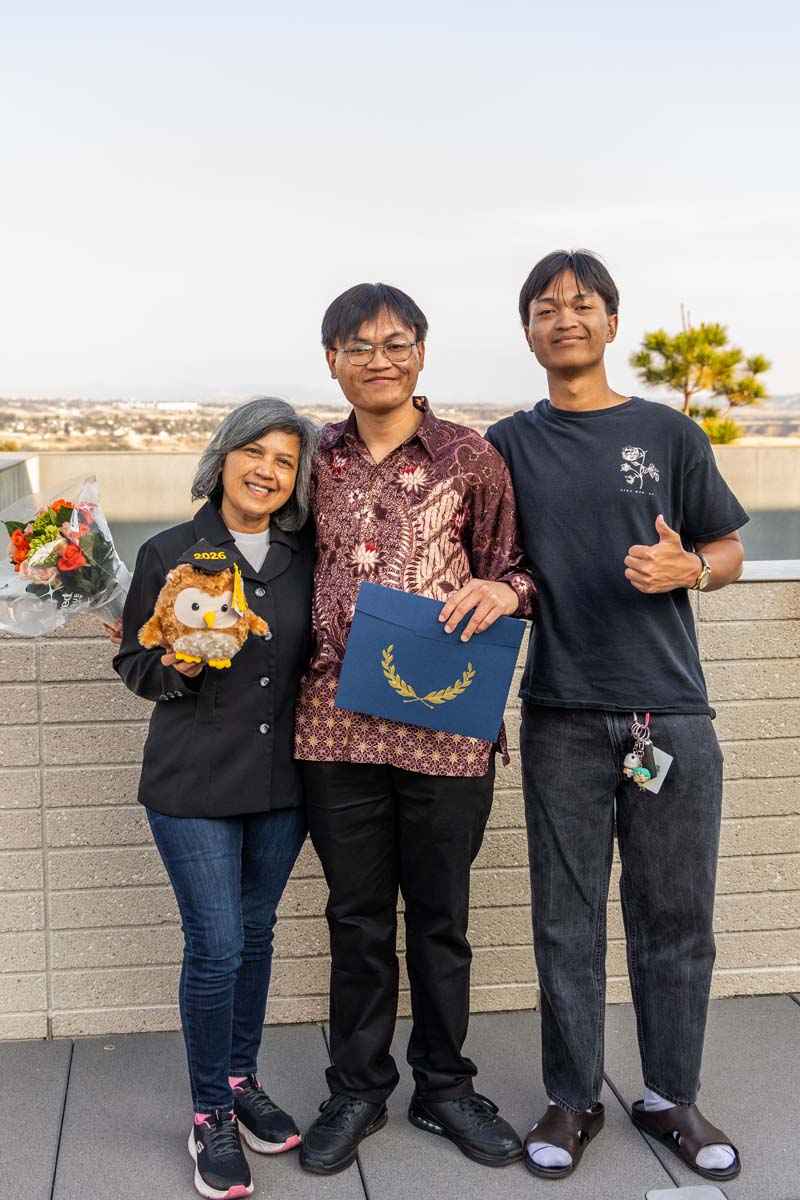 Student posing with family