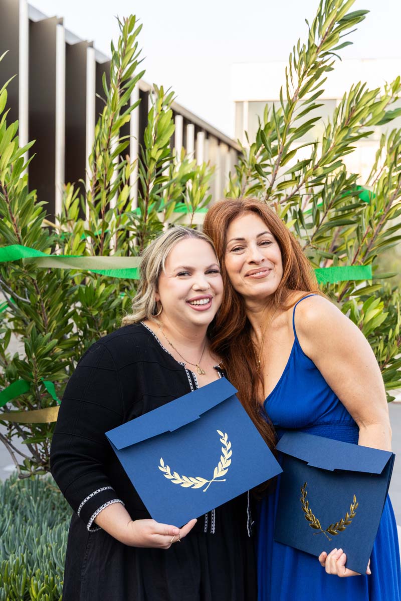 Two graduates posing for a photo
