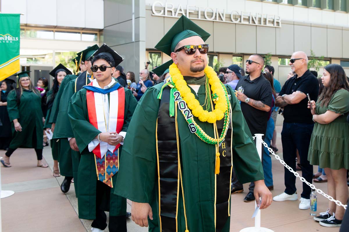 Grad walking to chair