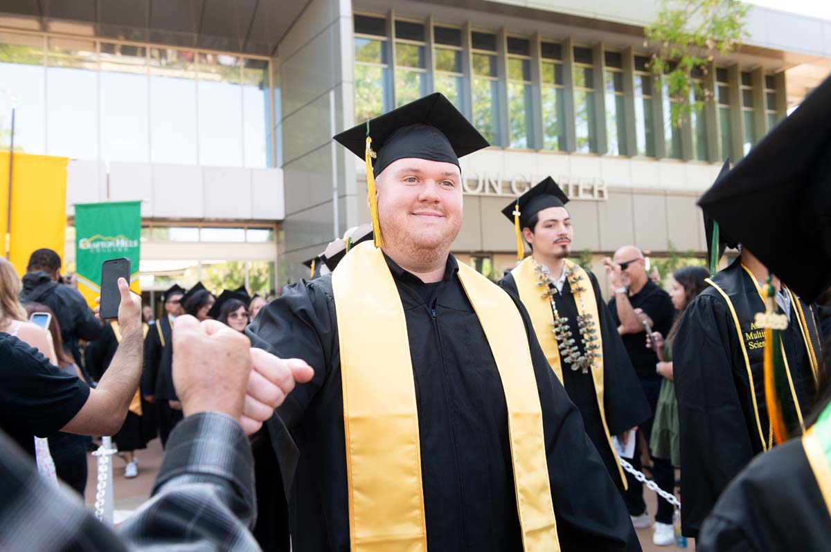 Grad walking to chair