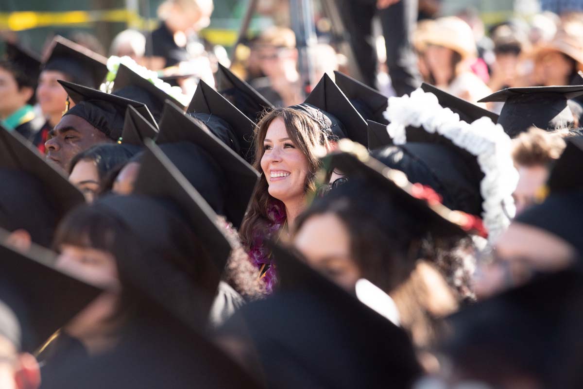 Grad smiling in the crowd