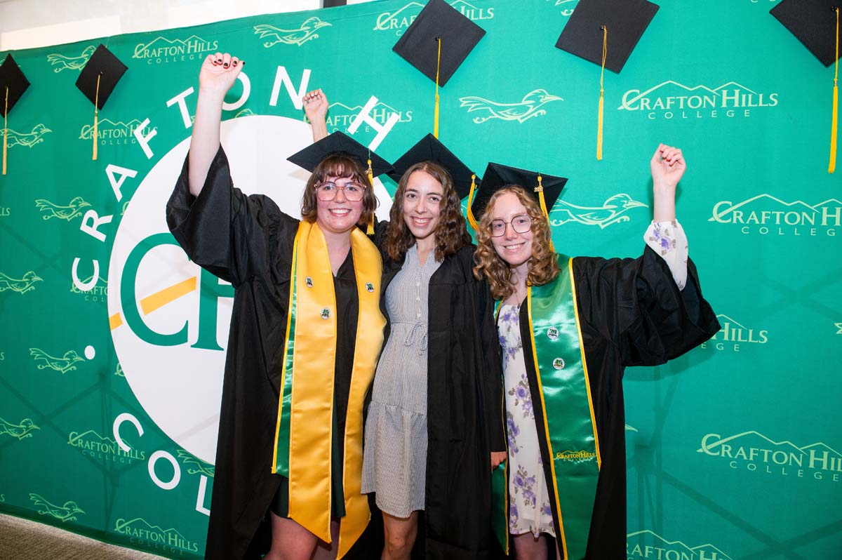 Three graduates posing