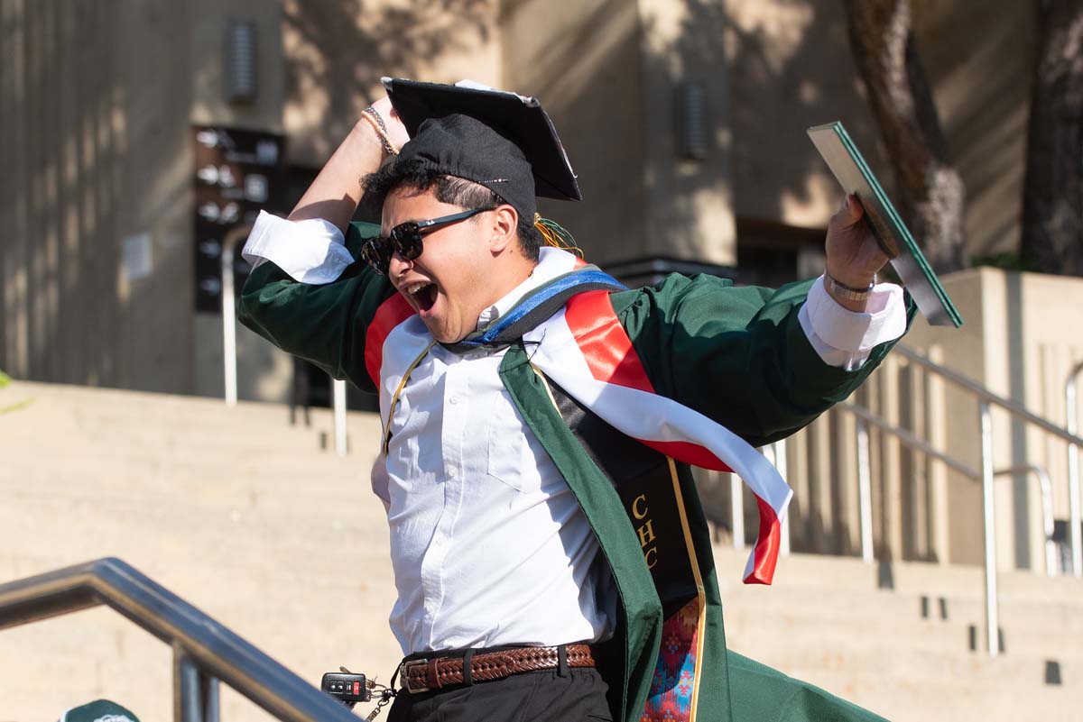 Grad walking across the stage