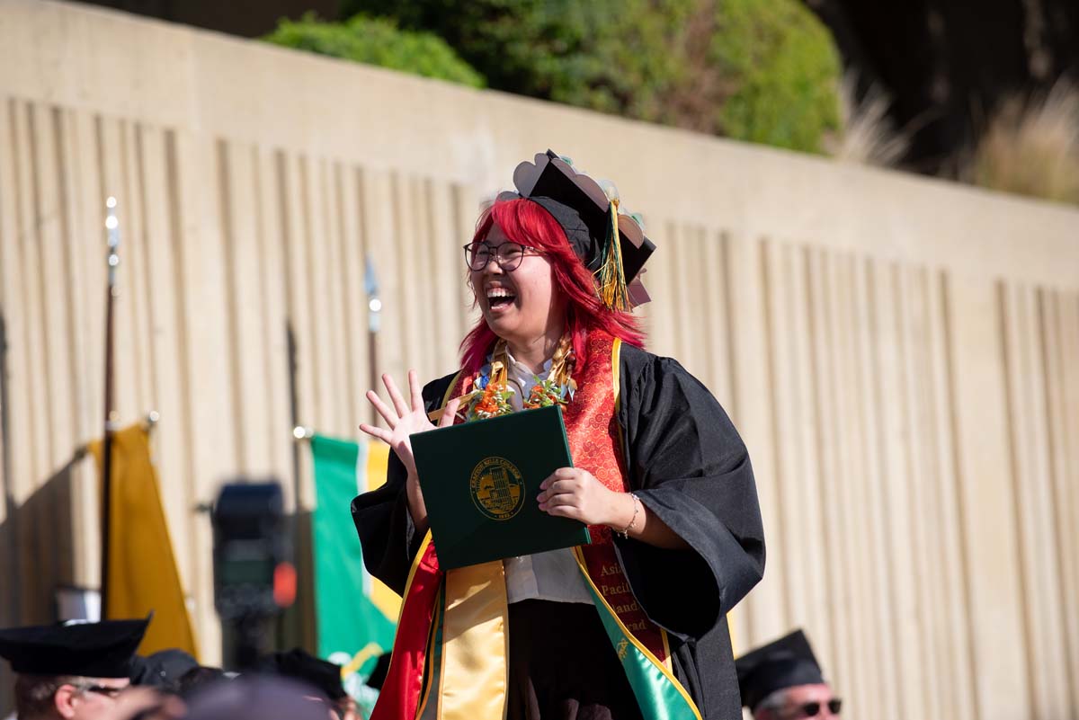 Grad walking across stage