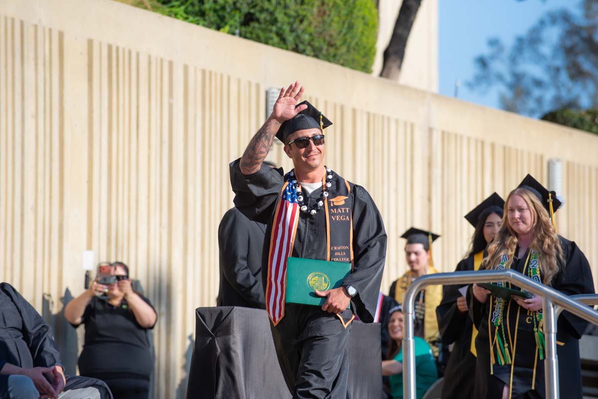 Grad walking across stage
