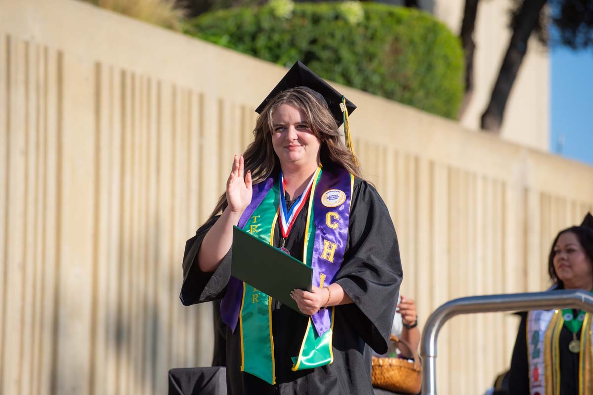 Grad walking across the stage