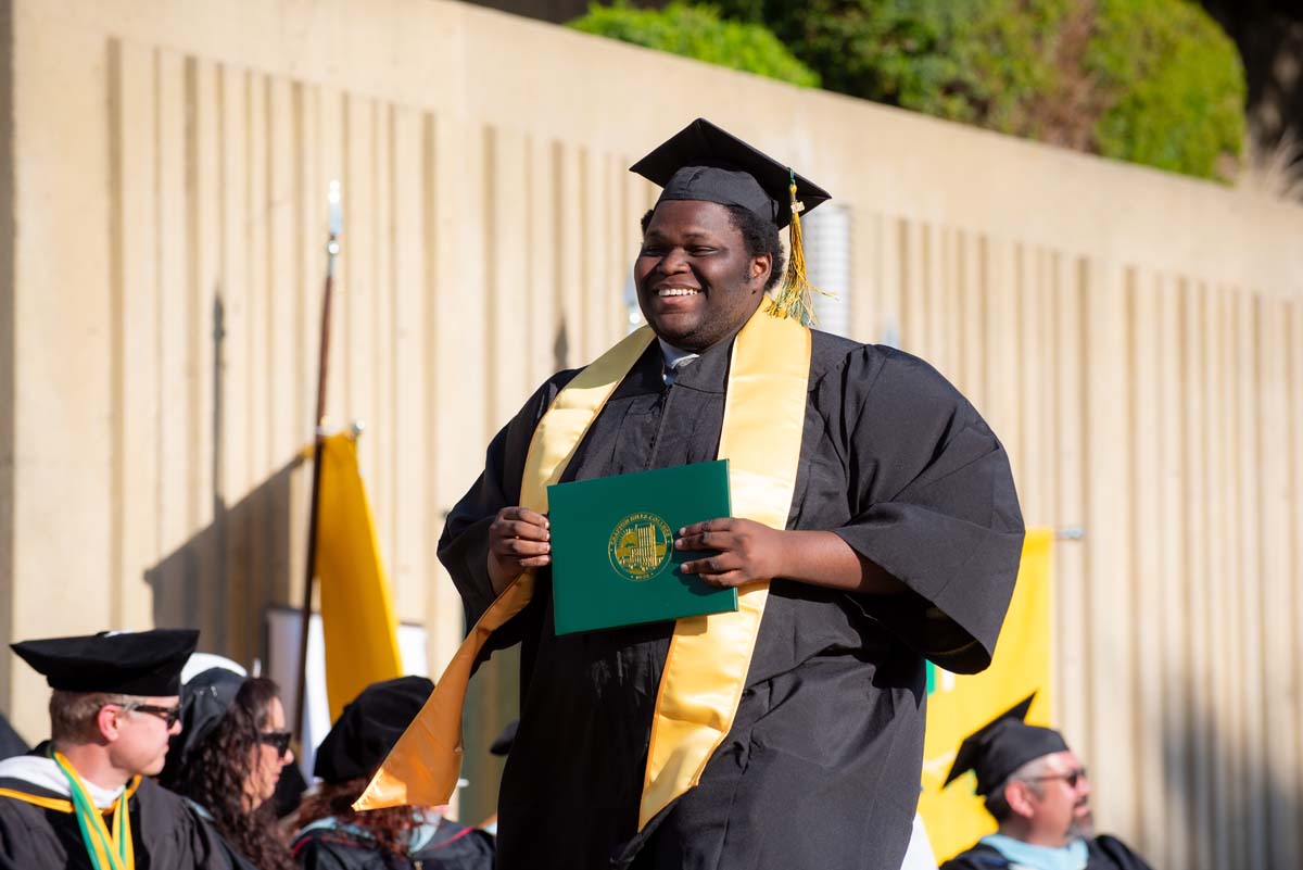 Grad walking across stage