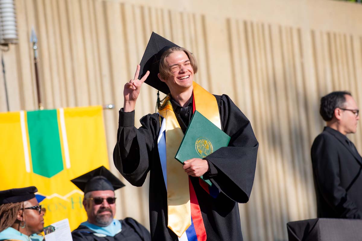 Grad walking across stage
