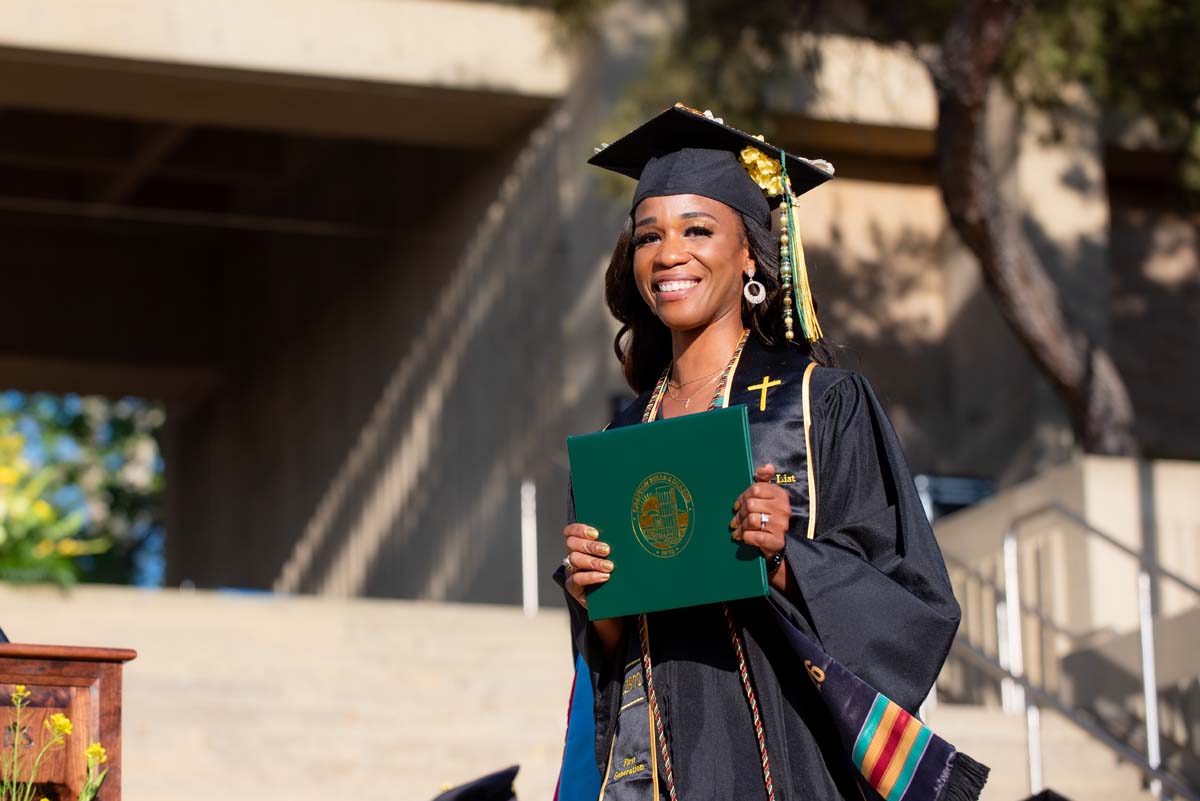 Grad walking across stage