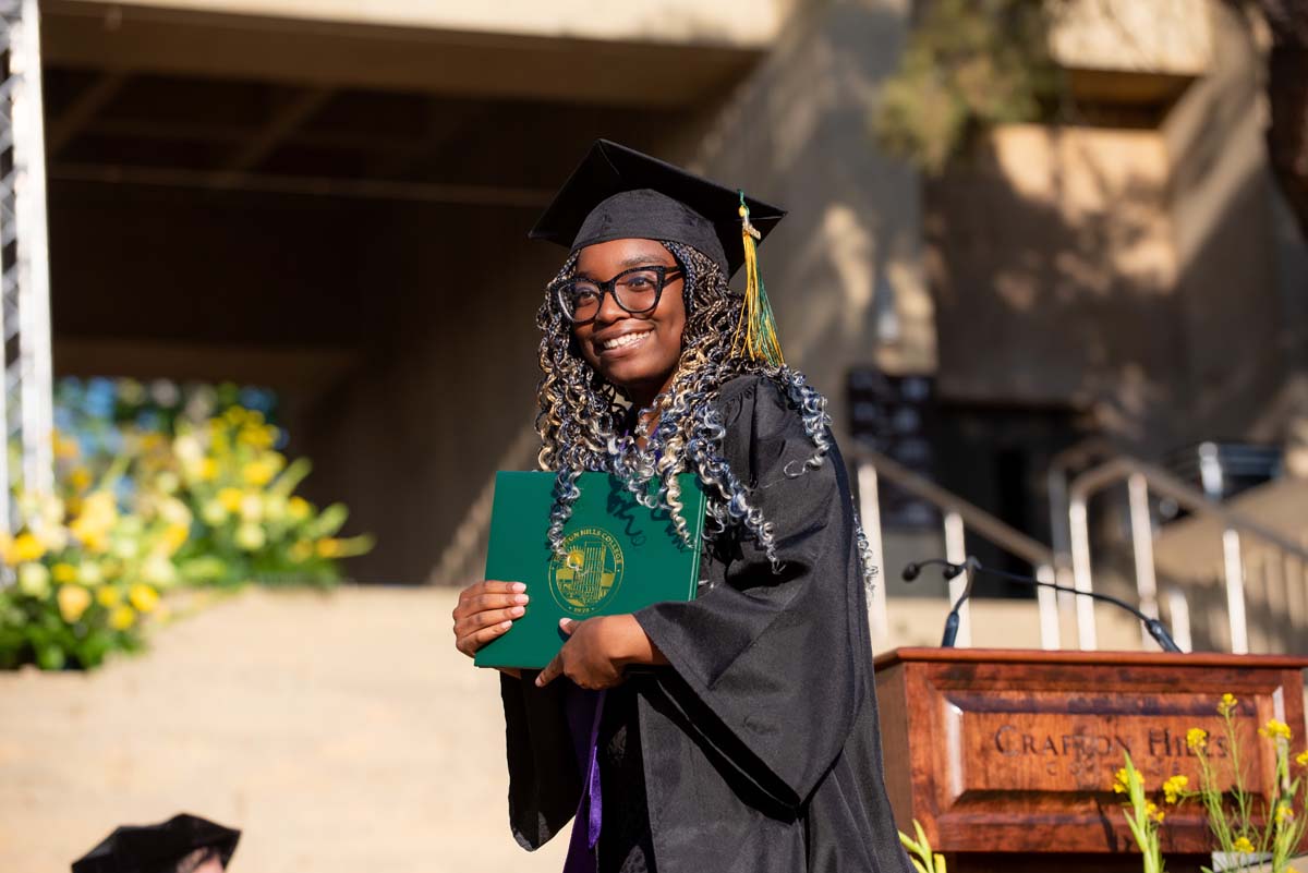 Grad wallking across stage