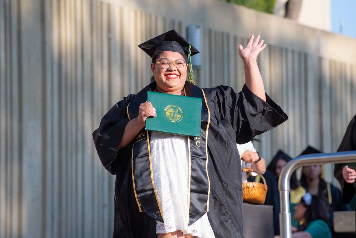 Grad walking across stage