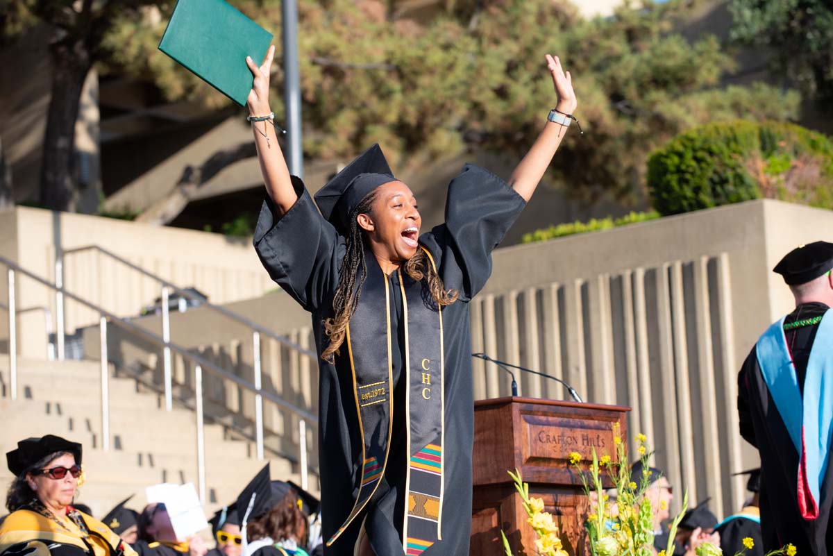 Grad walking across stage