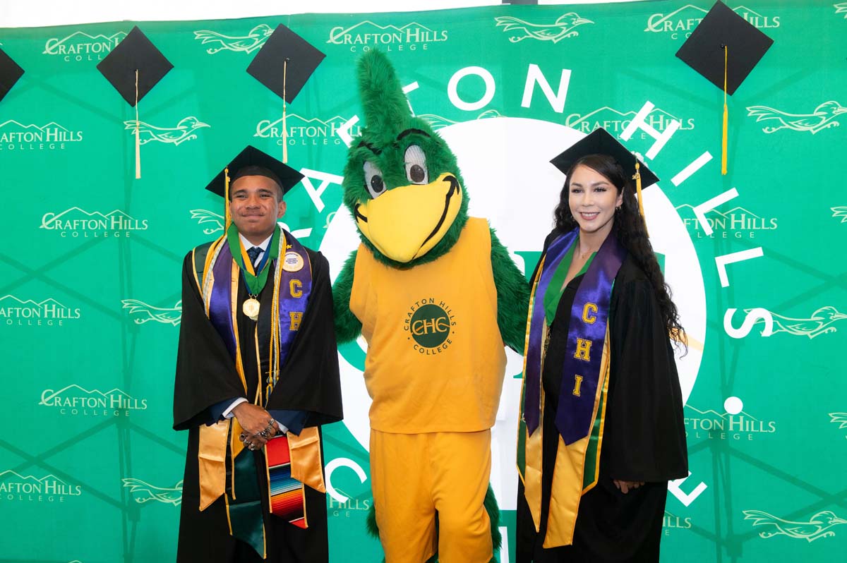 Two graduates posing with Ryker