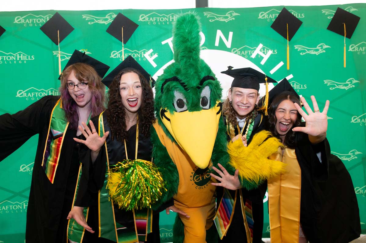 Four graduates posing with Rkyer