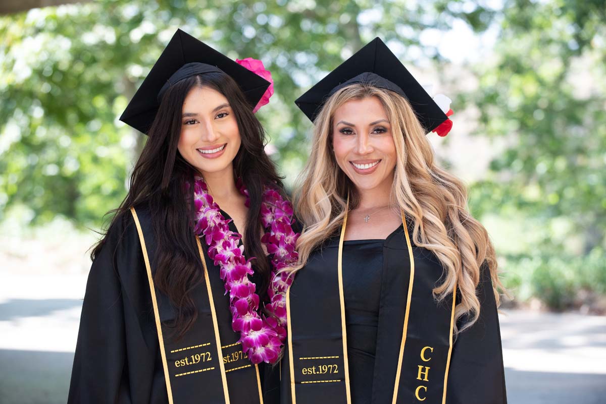 Two graduates posing