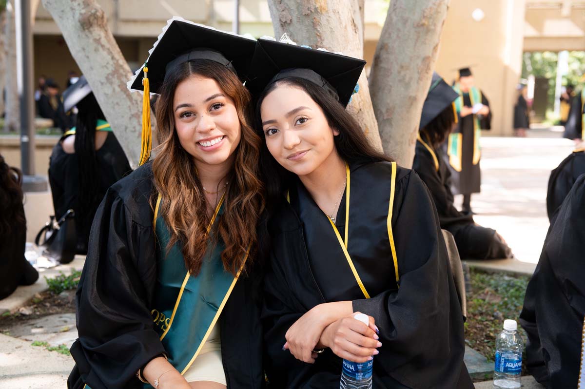 Two graduates posing