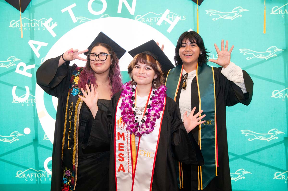 Three graduates posing