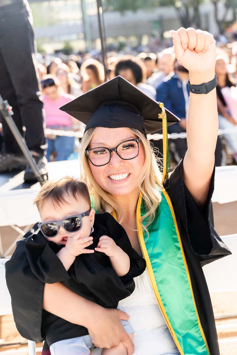 Grad holding their baby