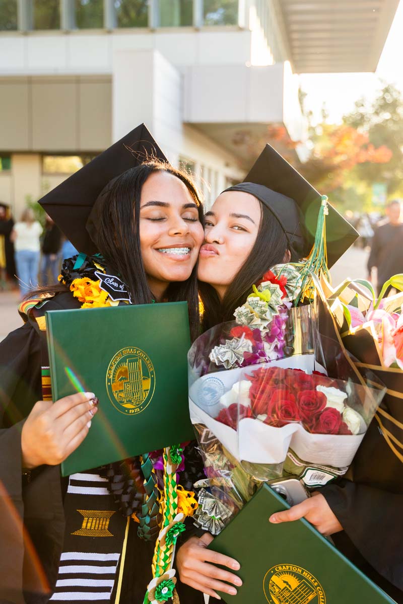 Two grads posing