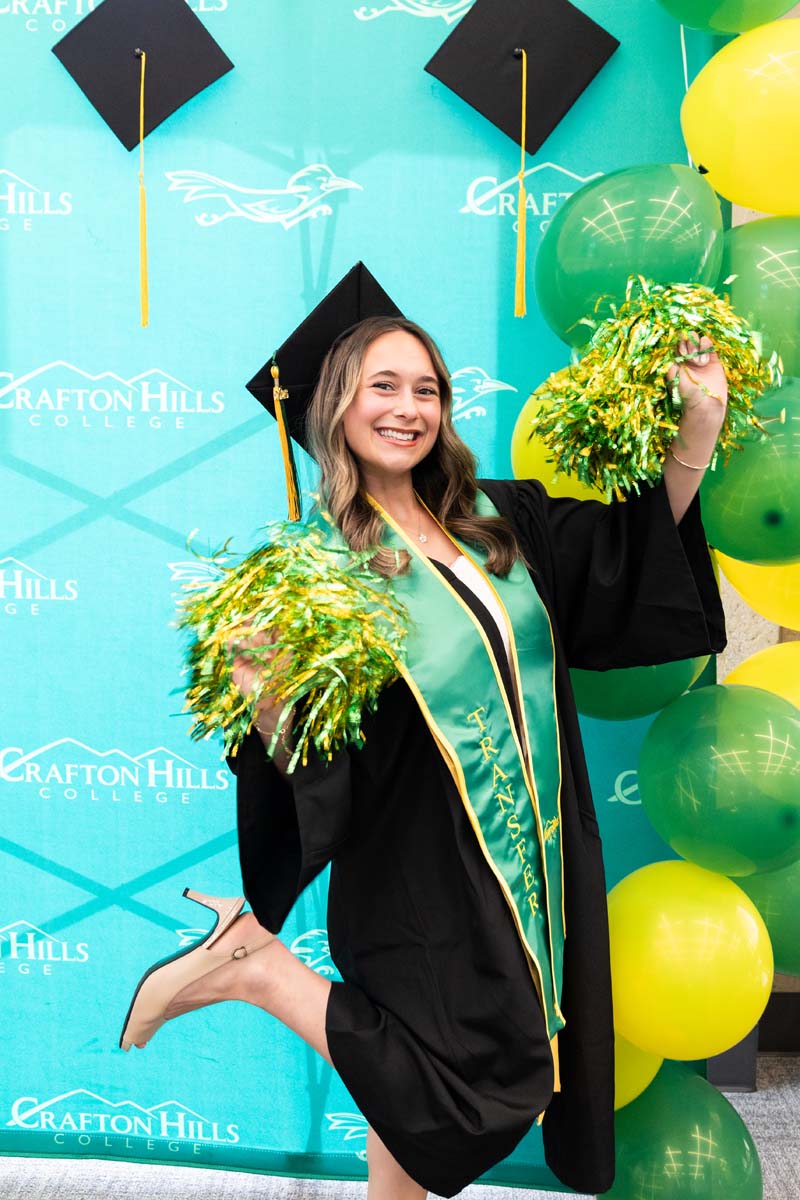 Grad posing wiht pom poms