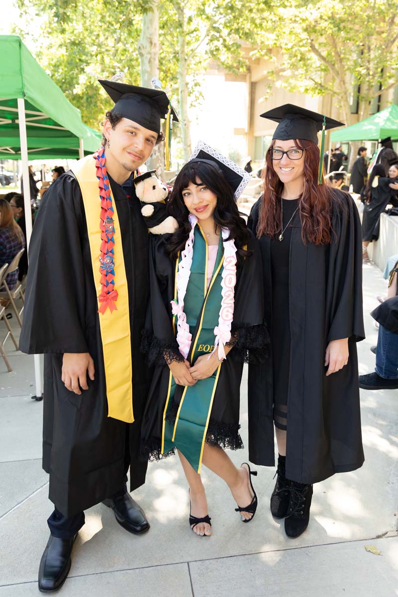 Three grads posing