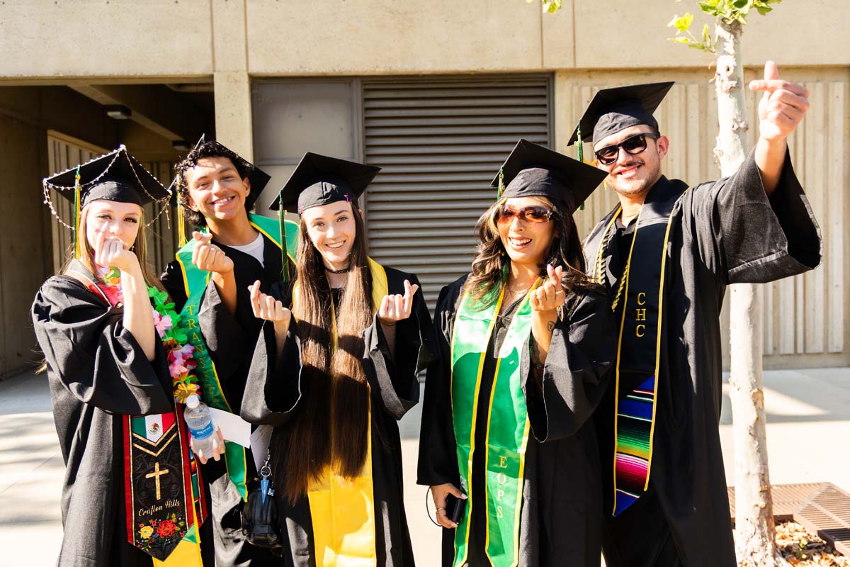 Five grad posing before the ceremony