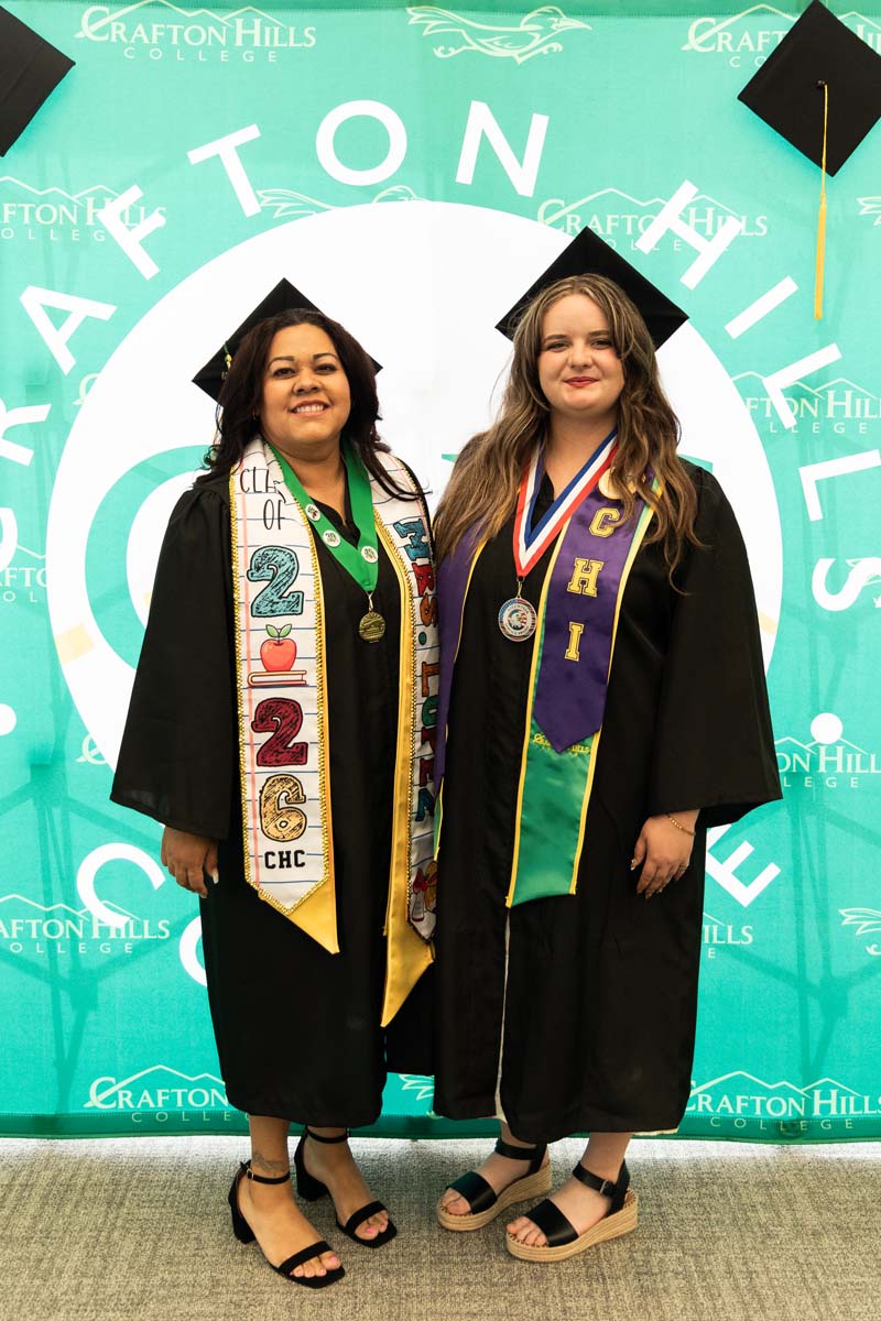 Two grads posing