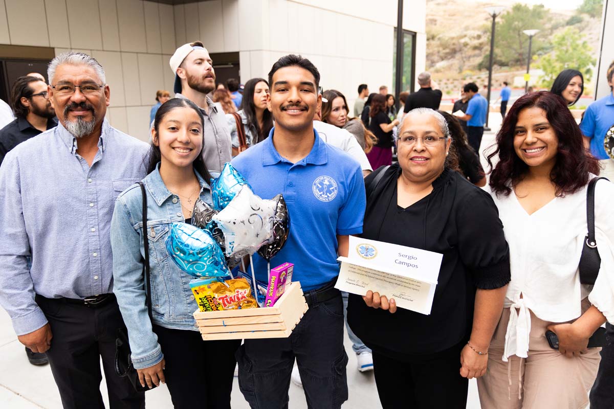 Grad posing with family