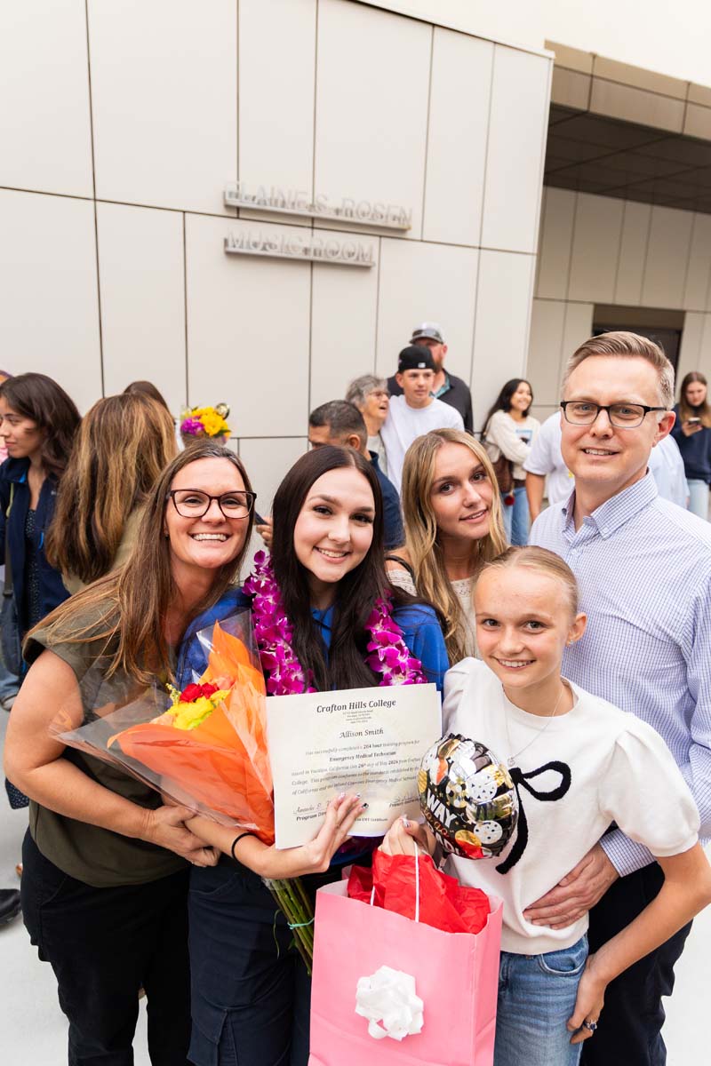 Grad posing with family