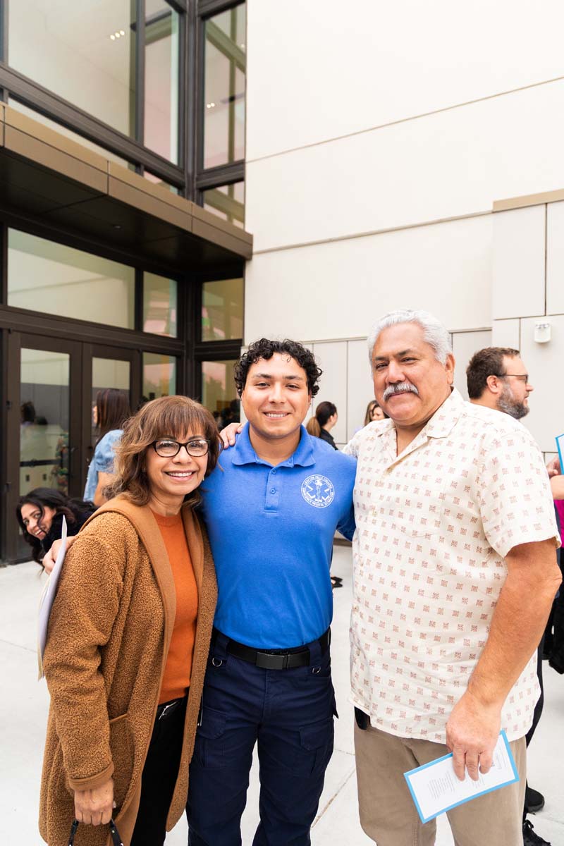Grad posing with family