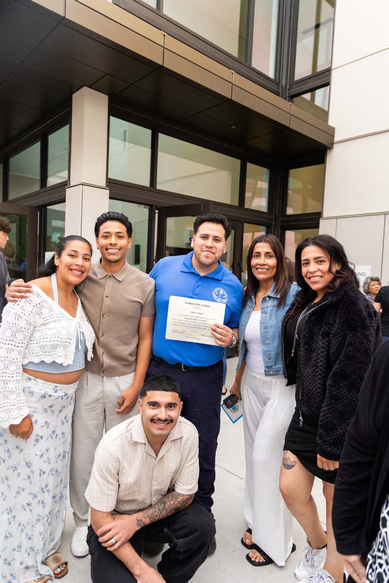 Grad posing with family