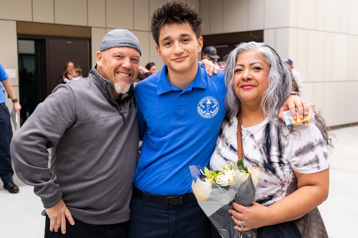 Grad posing with family